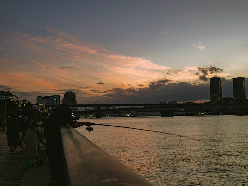 Fisherman casting line into river at sunset ,  photo from Unsplash