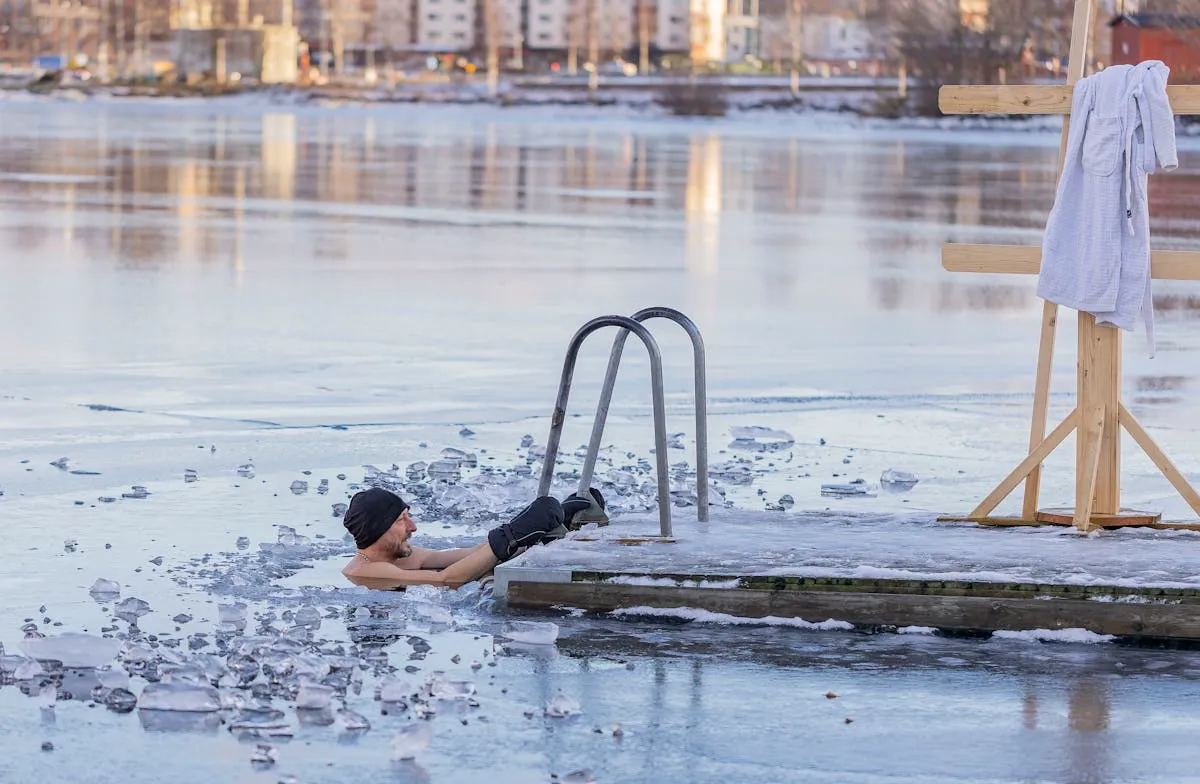A frozen lake in winter showing an ice fishing hut and drilled holes on the ice